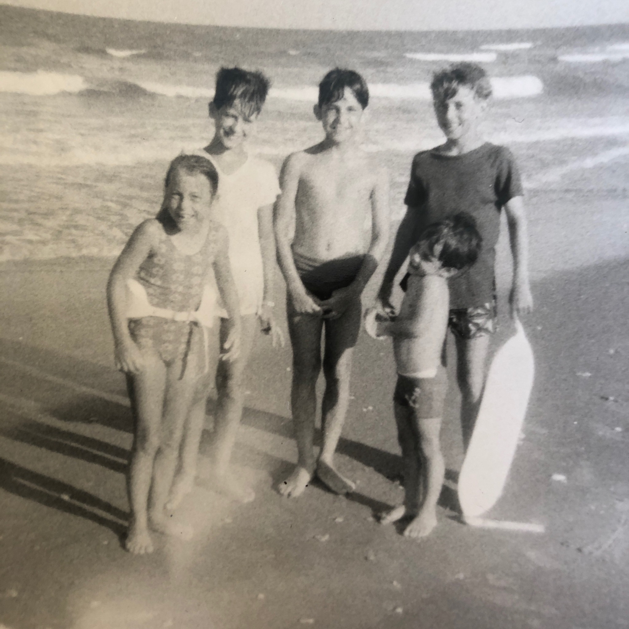 Five children on a beach in summer